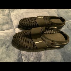 Waterproof slip on shoes in black . New. Size 9.5. Polyester netting on …